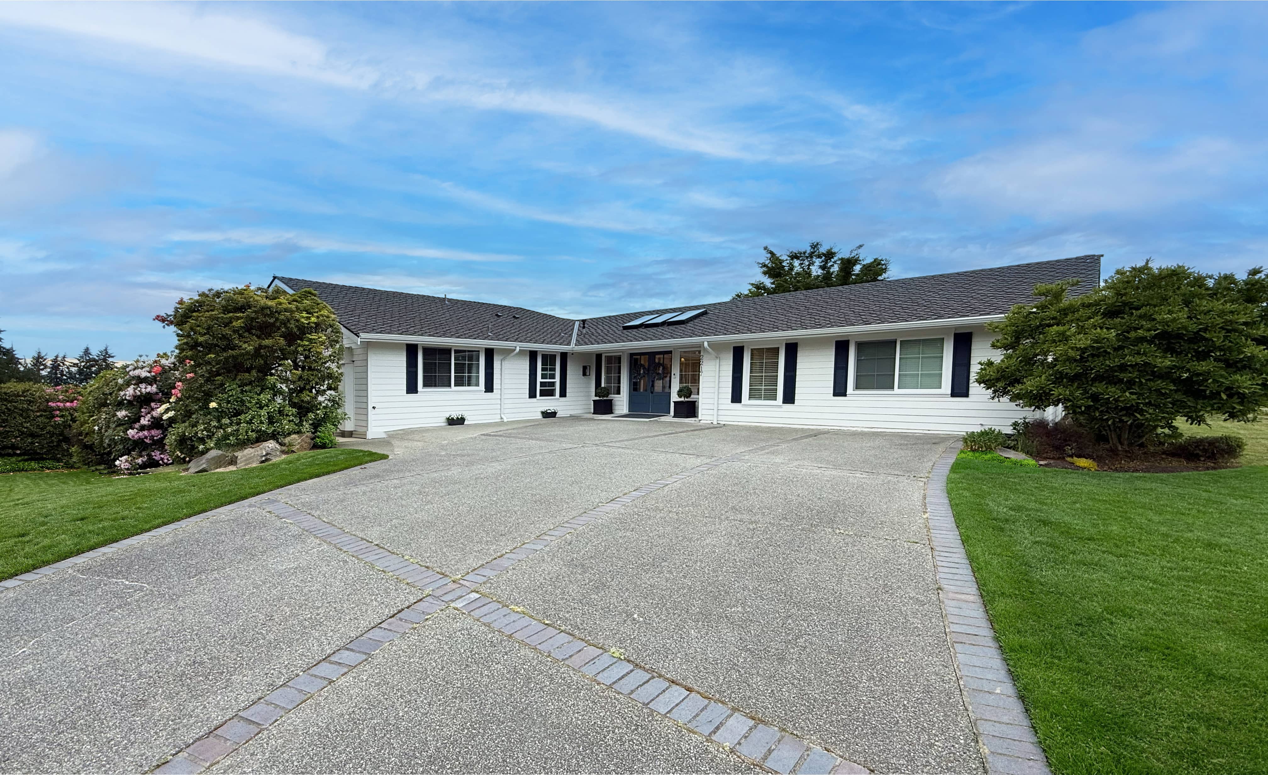 Second wide-angle view of the residence, showing the front yard and street.